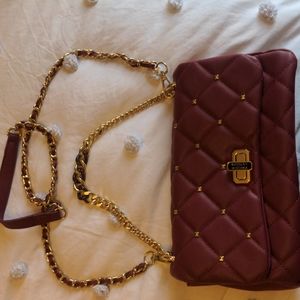 Quilted maroon Badgley Mischka shoulder bag with detachable long gold strap